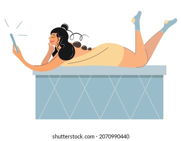 The Girl Takes Spa Treatments. A Woman Is Resting On A Marble Bed In A Sauna With A Phone. Vector With Cute Seductive Brunette. Spa - Hot Stone Massage. Rest, Stress Relief, Restoration Of Vitality.