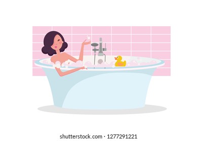 girl taking a bath full of soap foam. Yellow rubber duck in bathtub.