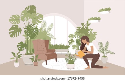 Girl Taking Care And Watering ZZ Plant With Funnel At Her Home Garden. Indoor Gardening Hobby. Jungles Inspired Interior In Modern City Apartment. Cozy And Calming Room Decorated With Many Pot Plants.