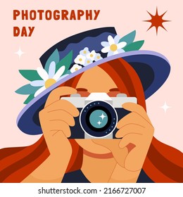 Girl taking a photo. Redheaded female photographer shooting with a camera and hat decorated with flowers. World phorography day. Flat hand drawn cartoon vector illustration