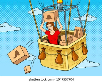 Girl throws out boxes with clothes and shoes from air balloon basket pop art retro vector illustration. Color background. Comic book style imitation.