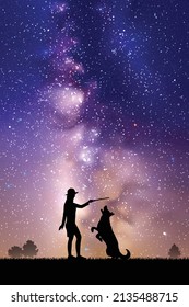 Girl trains dog at park. Woman and pet outline. Milky Way at night sky