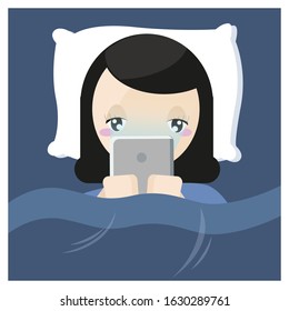 Girl using Tablet While Lying Under Blanket On The Bed