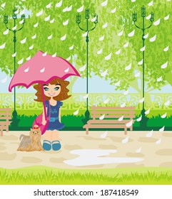 girl walking the dog in the rain