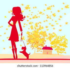  Girl walking with her dog in autumn landscape.