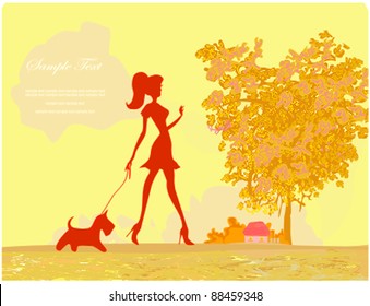 Girl walking with her dog  in autumn landscape.