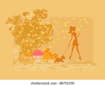 Girl walking with her dog in autumn landscape.