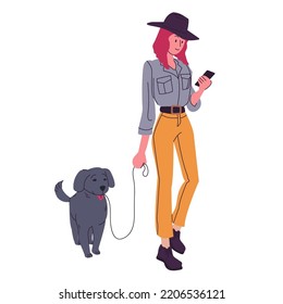 Girl walking her dog. Stylish woman in fashionable clothes looking at her phone