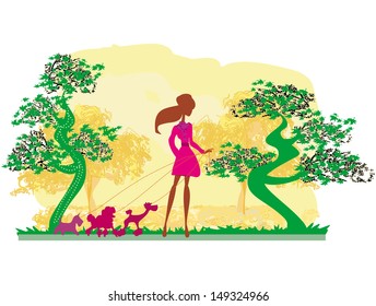  Girl walking with her dogs in autumn landscape. 
