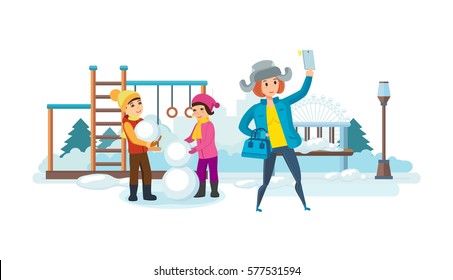 Girl In Warm Clothes With Phone In His Hand, Making Selfie On Background Of Kids, Park And Recreation Covered With Snow, Children Play On Winter Playground. Can Be Used In Banner, Mobile App, Design.