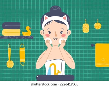 The girl washes her face in the bathroom. Skin care