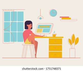
The girl is watching the news on the monitor, watching news.Girl sitting at a table behind a computer looking at the computer screen. Girl watching social network. Internet surfing concept. 