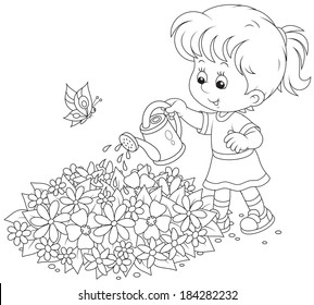 girl watering flowers on a flowerbed 