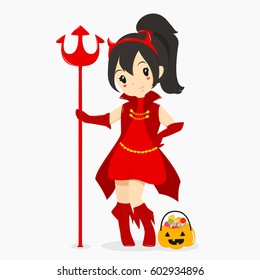a girl wearing Halloween red devil costume and holding a trident, with a pumpkin bucket full of candies.
