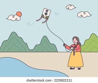 A girl wearing hanbok is flying a traditional Korean kite.