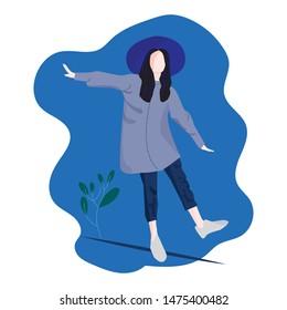 The girl wearing a hat is walking around to play.