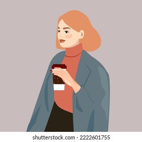 The girl is wearing a sweater coat and coffee in her hand. A cosy look for autumn or winter. The woman is drinking duckro coffee at work. Business lady, office employee, student. Redhead girl 