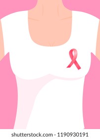 A girl in a white T-shirt short sleevewith a pinned pink ribbon on her chest.