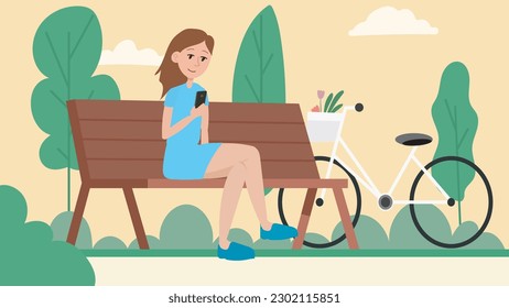 The girl who is sitting on a bench at the park and looking her telephone with a little smile on her face. Girl with blue dress and crossed her legs looking her telephone while sitting on a bench. 