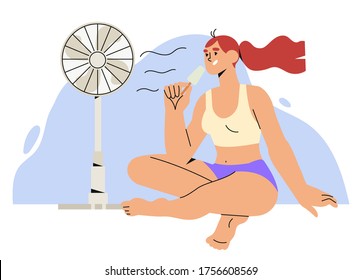 Girl or a woman sit on floor in front of an electric air fan during hot summer days and eat ice cream. Concept of air conditioning, refreshing and cooling.