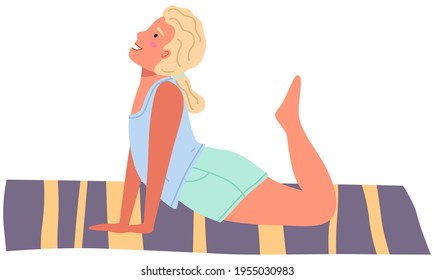 Girl working out doing exercise at home. Woman doing yoga on mat. Sportswoman stretches in apartment