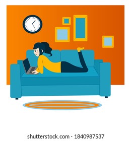 Girl works at a laptop while lying on the couch in the living room
