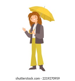 Girl with yellow umbrella stands in a pose and  waves her hand