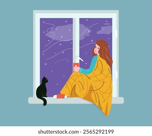 Girl, young woman with cat looking out the window. Winter season, snowflakes. View from the window on snowfall. Cup of tea, coffee, hot drink. Stay warm. Warm blanket, cold season, home comfort.