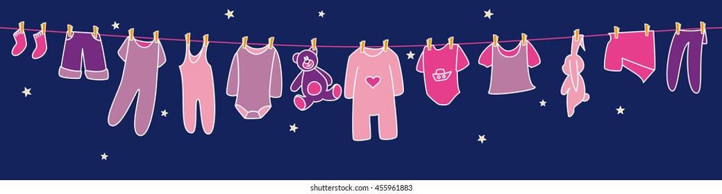 Girls' clothes and toys drying on the clothesline on sky background. Banner.