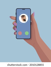 Girls hand with smartphone. Phone call. incoming call. Contact icon with bearded man on the screen. Blue background.