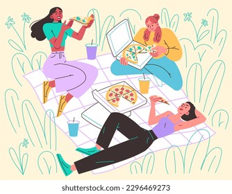 Girls in meadow on blanket eating pizza. Picnic, relaxing in nature