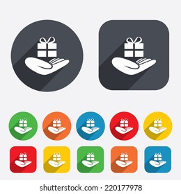 Give a gift sign icon. Hand holds present box with bow. Circles and rounded squares 12 buttons. Vector