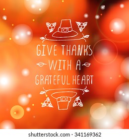 Give thanks with a grateful heart. Hand sketched graphic vector element with pilgrim hat and text on blurred background. Thanksgiving design.