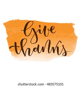 Give thanks hand lettering greeting on orange banner watercolor background
