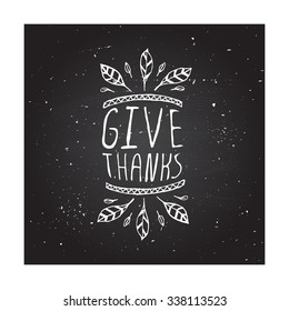 Give thanks. Hand sketched graphic vector element with feathers and text on chalkboard background.  Thanksgiving design.