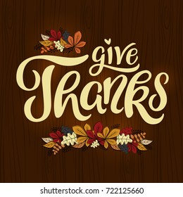 Give Thanks - Thanksgiving lettering card. Hand drawn text with decorative autumn leaves illustration. Vector, eps 10.