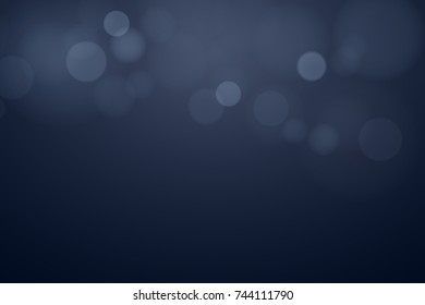 Glare bokeh on a dark background. Blue shine. Celebratory background. Abstract light background. Vector illustration