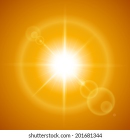 Glaring sun with lens flare over orange background