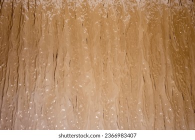 Glass with abstract relief pattern. Background patterned relief glass. Background glass surface with relief pattern
