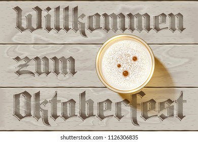 Glass of Beer on wooden background with german inscription Willkommen zum Oktoberfest. Top view on Beer Mug with foamy lager with bubbles. Realistic shadow, foam, table. Vector Illustration. No Mesh