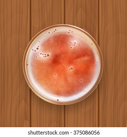 Glass of beer on a wooden surface. Top view. EPS10 vector