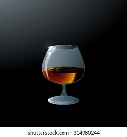A glass of brandy on dark background