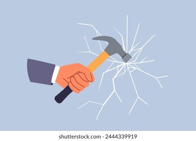 Glass breaks from blow from hammer held by hand of man trying to destroying unnecessary mirror partition. Concept of destroying barrier or vandalism during office robbery through window