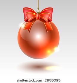 glass Christmas ball with red bow on a light background
