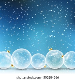 Glass Christmas baubles on a snowy background