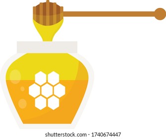 A glass container with honey and a wooden dipper