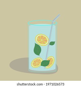 A glass of cooling lemonade with blue mint and lemon