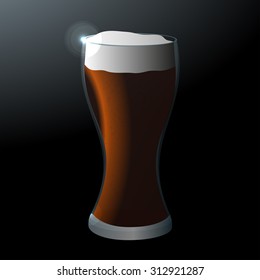 A glass of dark beer on a dark background