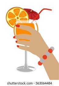 A glass of fresh orange juice, umbrella and drinking straw in hand of woman