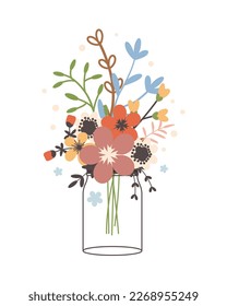 Glass jar with a bouquet of spring flowers. Cute simple vintage style.